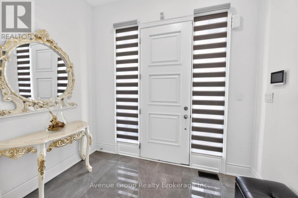 Entryway with modern door, gray tile flooring, and decorative mirror - 200 Farrell Road, Vaughan