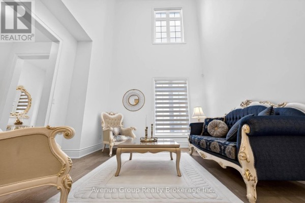 Living room with high ceilings, white walls, and elegant furniture - 200 Farrell Road, Vaughan