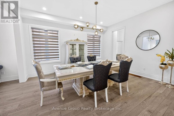 Dining room with a large table, upholstered chairs, and decorative lighting - 200 Farrell Road, Vaughan