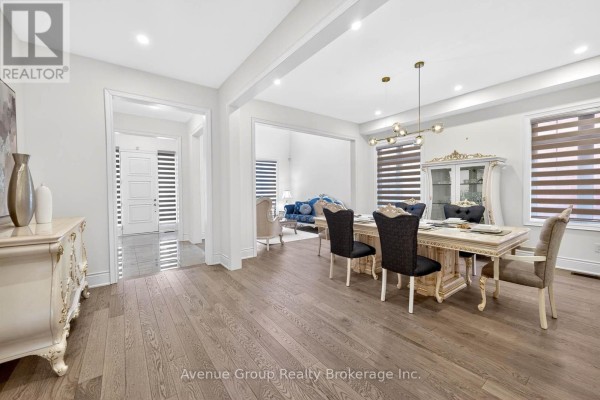 View from dining area into the living room, showcasing open layout and hardwood floors - 200 Farrell Road, Vaughan