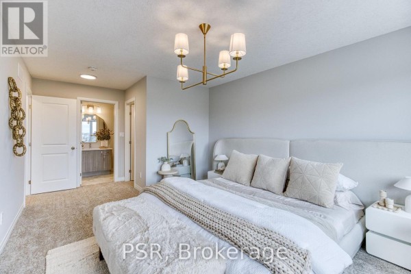Bedroom with a large bed, neutral color palette, plush carpet, and a modern chandelier. - 200 Rivergreen Crescent, Cambridge