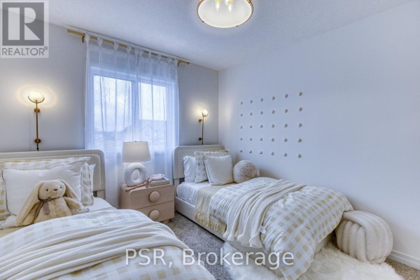 Bedroom with two beds, plaid bedding, and decorative wall dots - 200 Rivergreen Crescent Waterloo