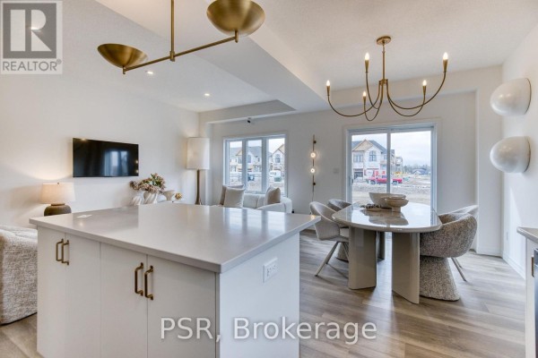 Modern open-concept living area with kitchen island and dining table - 200 Rivergreen Crescent Waterloo
