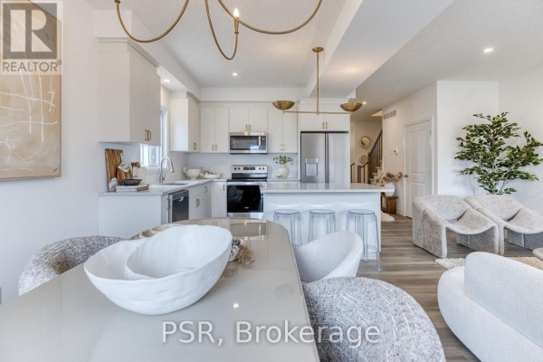 Modern kitchen with island and stainless steel appliances - 200 Rivergreen Crescent Waterloo