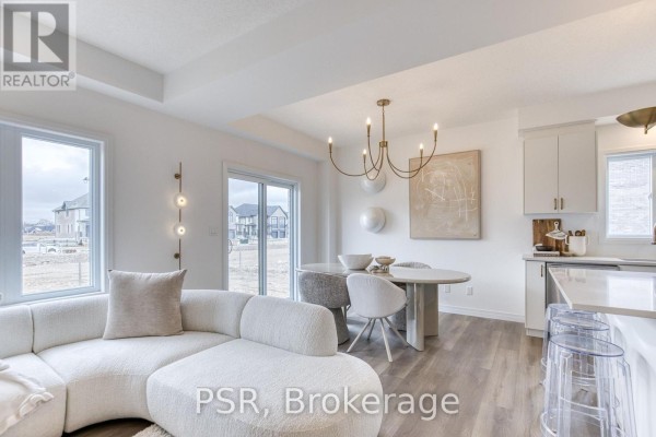 Modern living room with sectional sofa, dining area, kitchen island & chandelier - 200 Rivergreen Crescent Waterloo