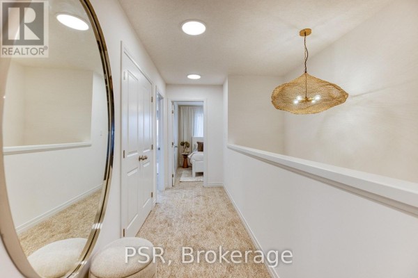 Hallway with large mirror, pendant light, and plush carpet - 200 Rivergreen Crescent Waterloo