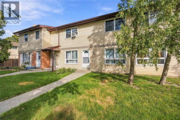 Side exterior view of the townhouse complex showcasing the entrance. - 200 St.clair Boulevard Unit# 44, St Clair