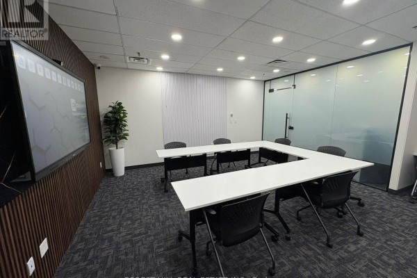 Conference room with U-shaped table, chairs, and floor-to-ceiling frosted glass wall. - 200 Suite 1-4 - 350 Burnhamthorpe Road W, Mississauga
