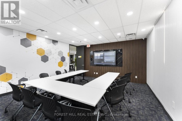 Bright meeting room with U-shaped table, chairs, and geometric pattern accent wall. - 200 Suite 1-4 - 350 Burnhamthorpe Road W, Mississauga