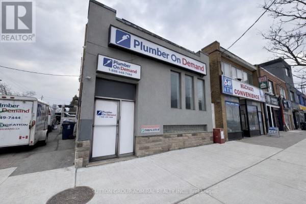 Side view of the commercial property with signage and street visibility. - 2000 Eglinton Avenue W, Toronto
