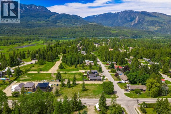 Aerial view of residential lots and surrounding neighbourhood with mountains and water in distance. - 2000 Lanzo Lane Lot# Sl 1, Revelstoke