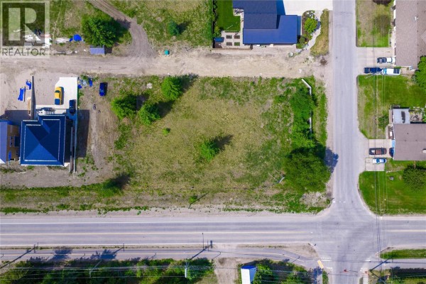 Overhead view of a cleared lot with grass and trees adjacent to a paved road. - 2000 Lanzo Lane Lot# Sl 1, Revelstoke