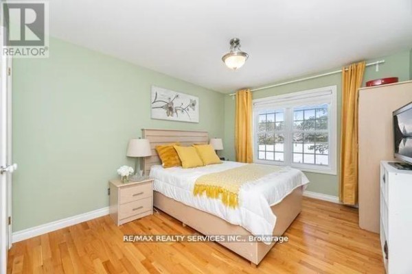 Bedroom with hardwood floors, window, and TV - 20040 Kennedy Road, Caledon