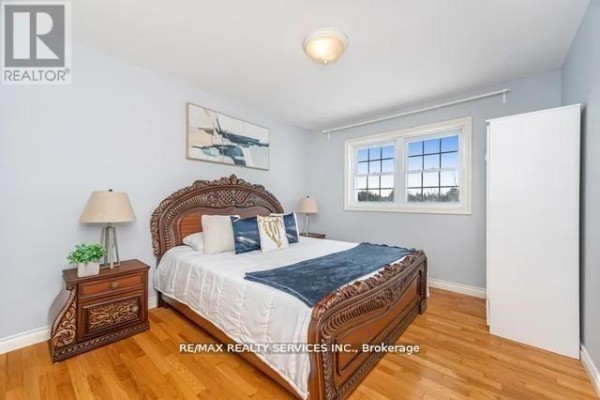 Bedroom with hardwood floors, large window, and wardrobe - 20040 Kennedy Road, Caledon