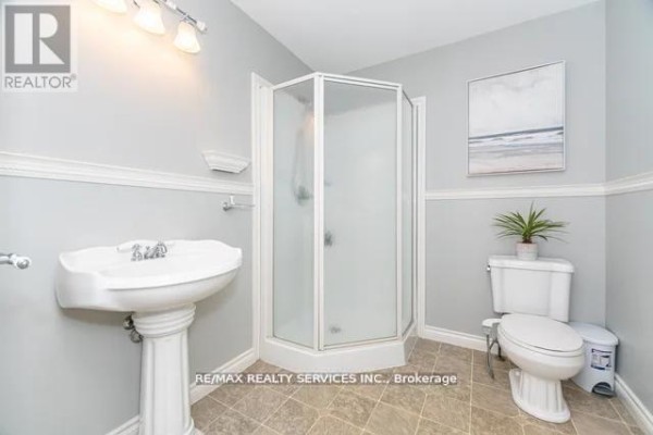 Bathroom with pedestal sink, corner shower, toilet, and tiled floor - 20040 Kennedy Road, Caledon