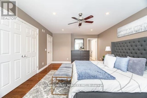 Modern bedroom with hardwood floors, ceiling fan, tufted headboard - 20040 Kennedy Road, Caledon