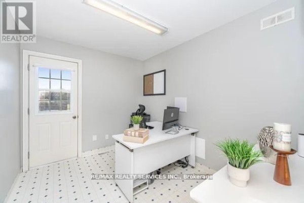 Office room with desk, computer, and windowed door - 20040 Kennedy Road, Caledon