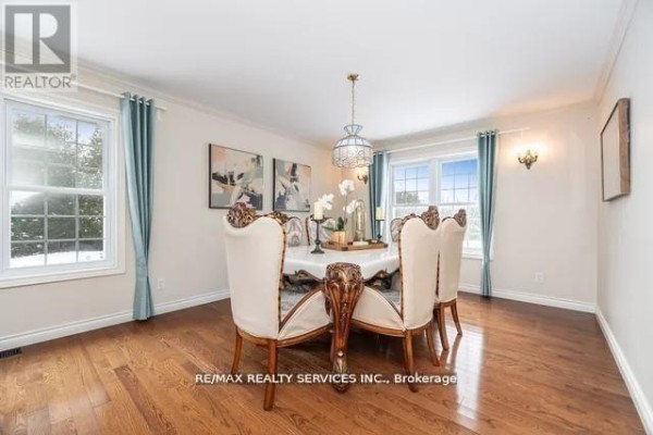 Dining room with hardwood floors, chandelier, crown molding, and windows - 20040 Kennedy Road, Caledon