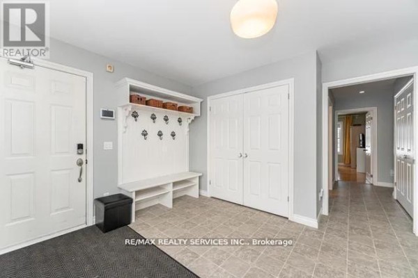 Entryway with built-in bench, coat hooks, and double closet - 20040 Kennedy Road, Caledon