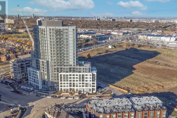 Aerial view of a tall apartment building surrounded by urban landscape. - 2005 - 225 Malta Avenue, Brampton