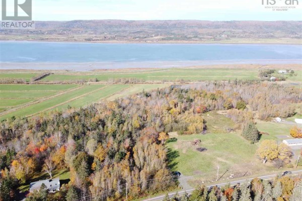 Aerial view of wooded land and fields bordering a wide body of water during autumn. - 2008-1 Highway 1, Upper Clements