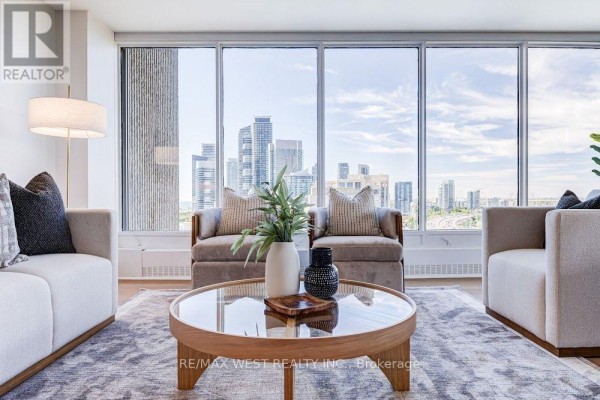 Close-up of a living room coffee table with decorative items and a city view through the windows. - 2009 - 2045 Lake Shore Boulevard W, Toronto