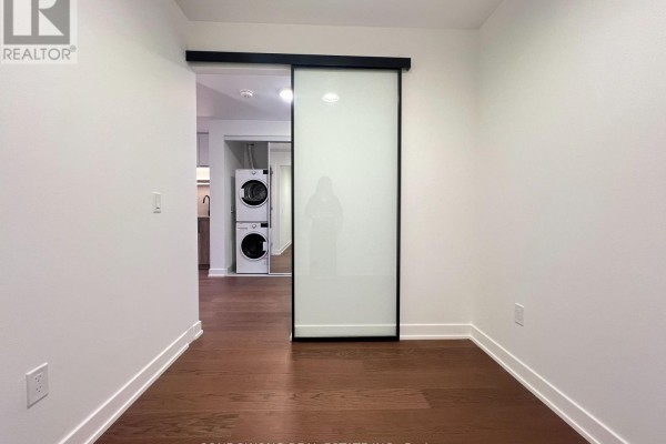 View from entrance showing hallway, kitchen, and living area with balcony. - 518 - 91 Montclair Avenue, Toronto