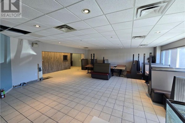 Empty commercial space with tiled floors, booth seating, and tables. - 2009 Long Lake Road Unit# 104, Sudbury