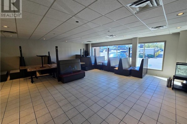 Wide view of commercial space with booth seating, tables, and windows. - 2009 Long Lake Road Unit# 104, Sudbury