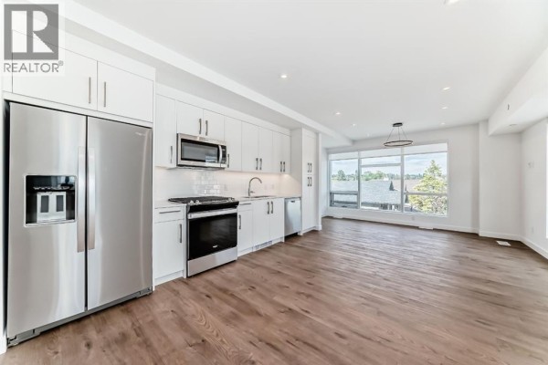 Living room - 201, 110 18a Street Nw, Calgary, AB T2N5G5 Photo 2