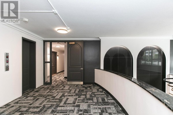 Spacious living room with parquet flooring and natural light - 201 - 10 Shallmar Boulevard, Toronto