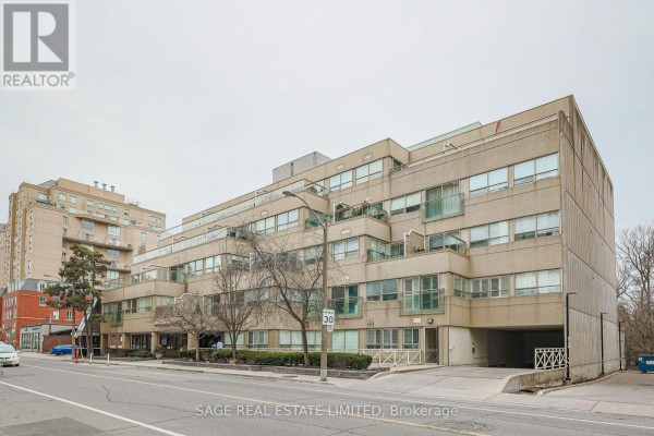 Side view of the beige, multi-story Greenwich Terrace apartment building on Merton Street. - 201 - 111 Merton Street S, Toronto