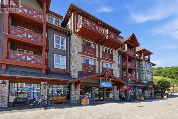 Close-up of the apartment building entrance with shops and balconies. - 201 - 152 Jozo Weider Boulevard, Blue Mountains