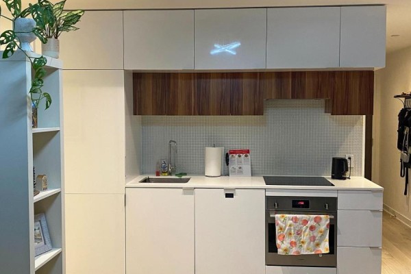 Close-up of the modern kitchen with white counters, wooden cabinets, and stainless steel appliances. - 201 - 185 Roehampton Avenue, Toronto