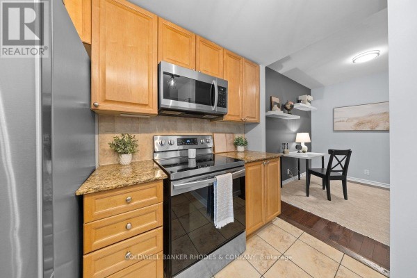 Kitchen area with light wood cabinets, stainless steel appliances, and granite countertops. - 201 - 200 Lett Street, Ottawa