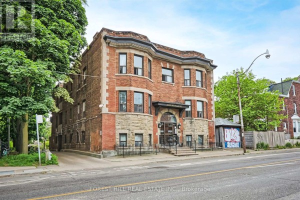 Side view of brick apartment building with trees and city street. - 201 - 333 Harbord Street, Toronto