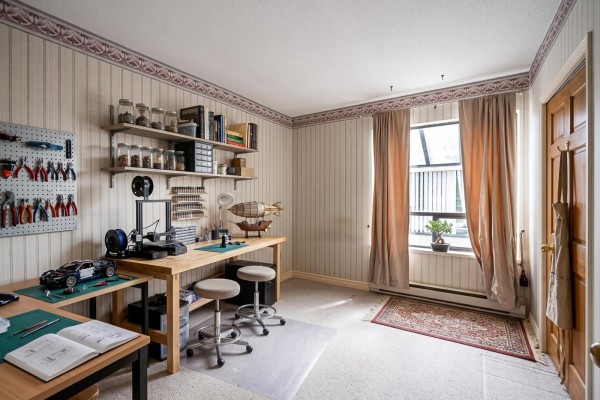 Spacious living area with carpet, fireplace, and natural light. - 201 14957 Thrift Avenue, White Rock