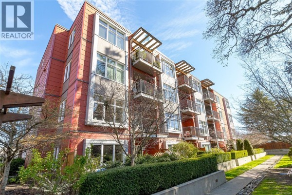 Open concept kitchen with granite island, stainless steel appliances, and large window view. - 201 4030 Borden St, Saanich