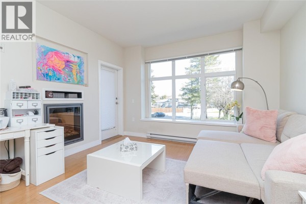 Close-up of a kitchen stove with stainless steel finish and granite countertops. - 201 4030 Borden St, Saanich