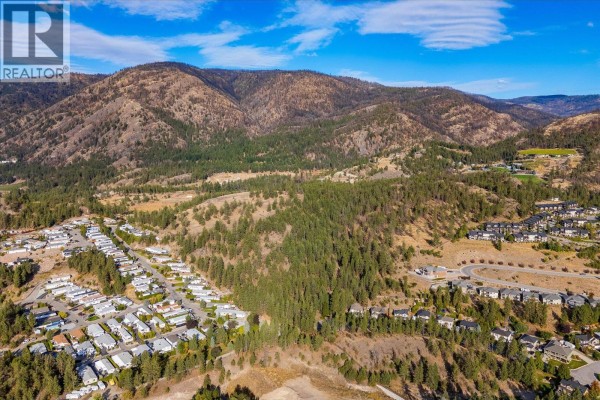 Panoramic aerial shot of the undeveloped land at 2010 Bartley Road Lot# 2, West Kelowna, with distant hills. - 2010 Bartley Road Lot# 2, West Kelowna