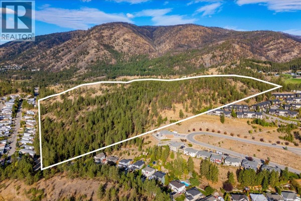 Drone footage captures the entirety of 2010 Bartley Road Lot# 2, West Kelowna, a large, tree-covered property. - 2010 Bartley Road Lot# 2, West Kelowna