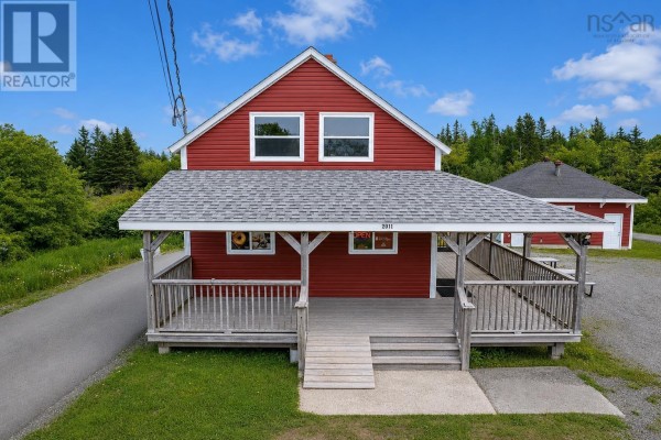 Aerial view of the red commercial building with a wraparound porch and a separate smaller red building in the background. - 2011 Louisbourg Highway, Mira Road