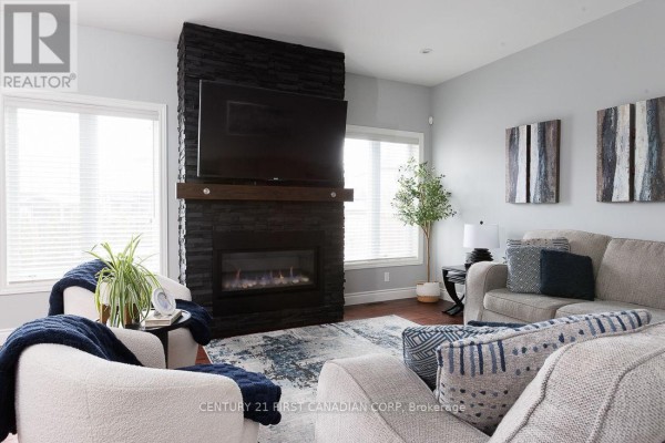 Living room with gas fireplace and mounted TV - 2014 Ballymote Avenue London North