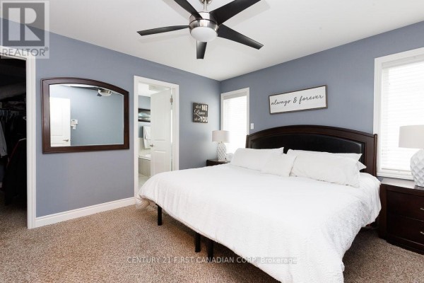 Bedroom with king-size bed, ceiling fan, and mirror - 2014 Ballymote Avenue London North