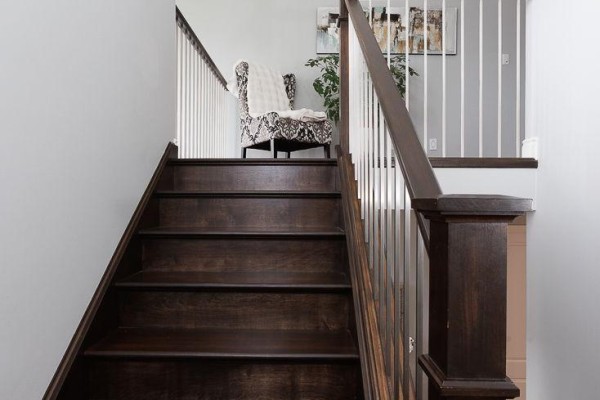 Dark wood staircase and white banister with armchair - 2014 Ballymote Avenue London North