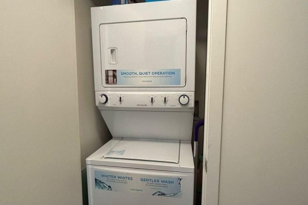 Stackable white Frigidaire washer and dryer units in a closet. - 2016 - 105 The Queensway Street, Toronto
