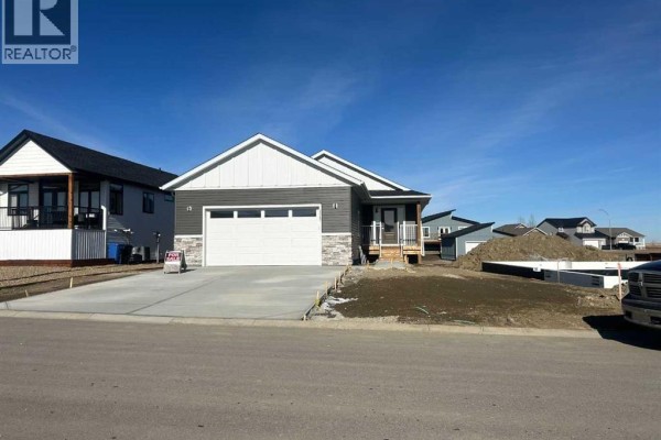 Side angle of the house with steps leading to the entrance and snow - 2017 30 Avenue, Nanton