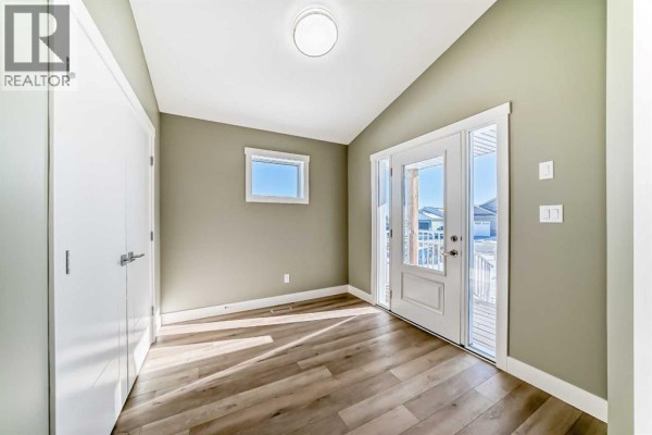 Entryway with light-colored walls, wood flooring, and a front door - 2017 30 Avenue, Nanton