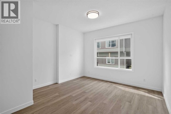 Primary Bedroom - 202, 101 Panatella Square Nw, Calgary, AB T3K2R9 Photo 5