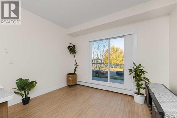 Living room - 202, 15233 1 Street Se, Calgary, AB T2X0X5 Photo 5